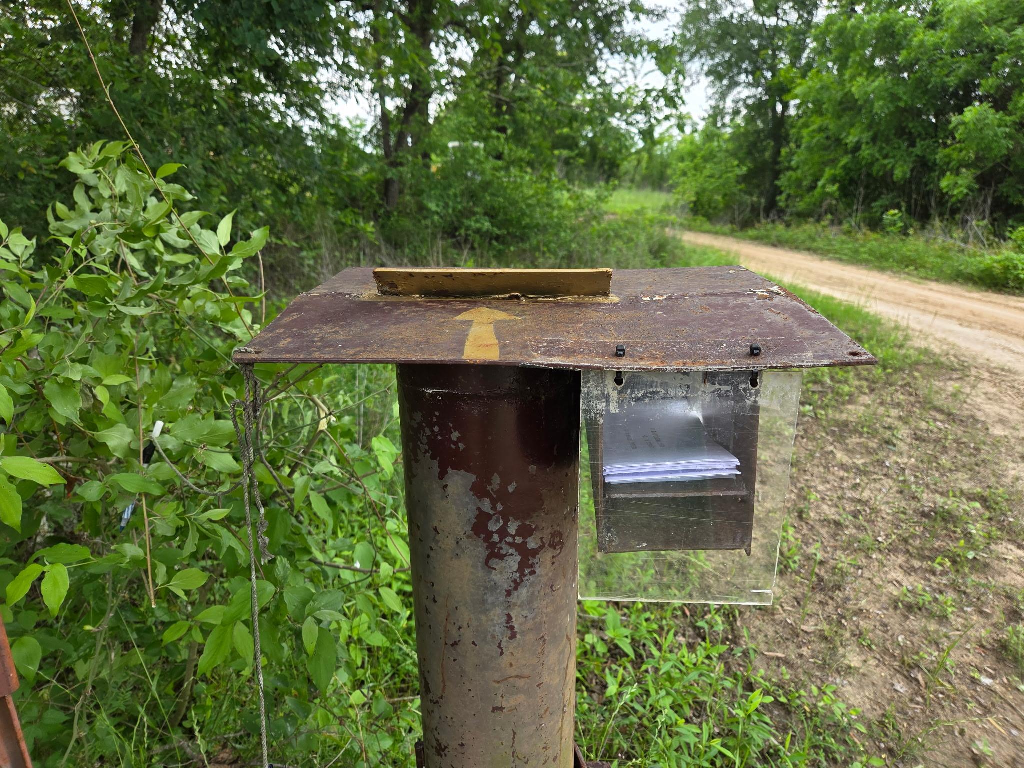 Envelope holder and payment slot on the pay station post
