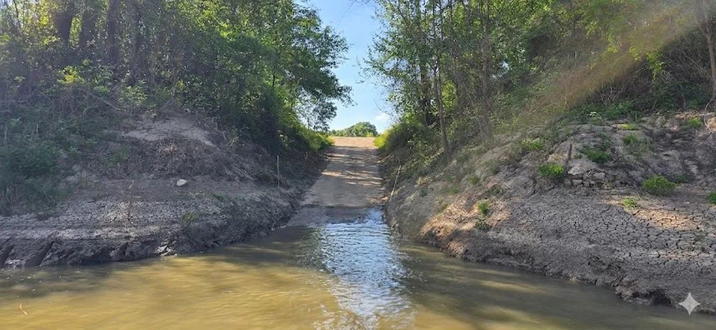 Trinity River concrete boat ramp at low water on a sunny day