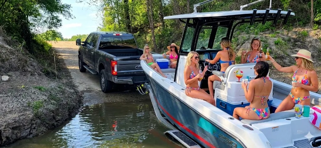 Group of friends launching a center-console boat at the ramp